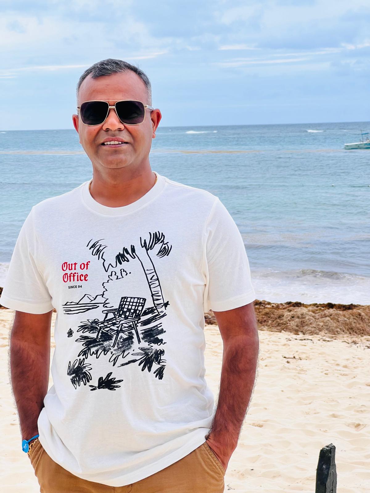Mahendra Jangir on a beach, travelling with family